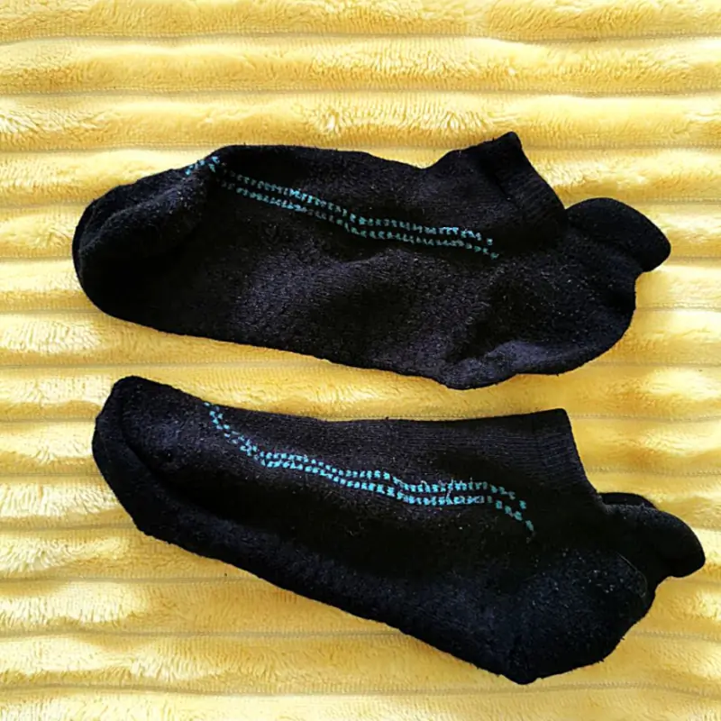 Old black socks w green stitch